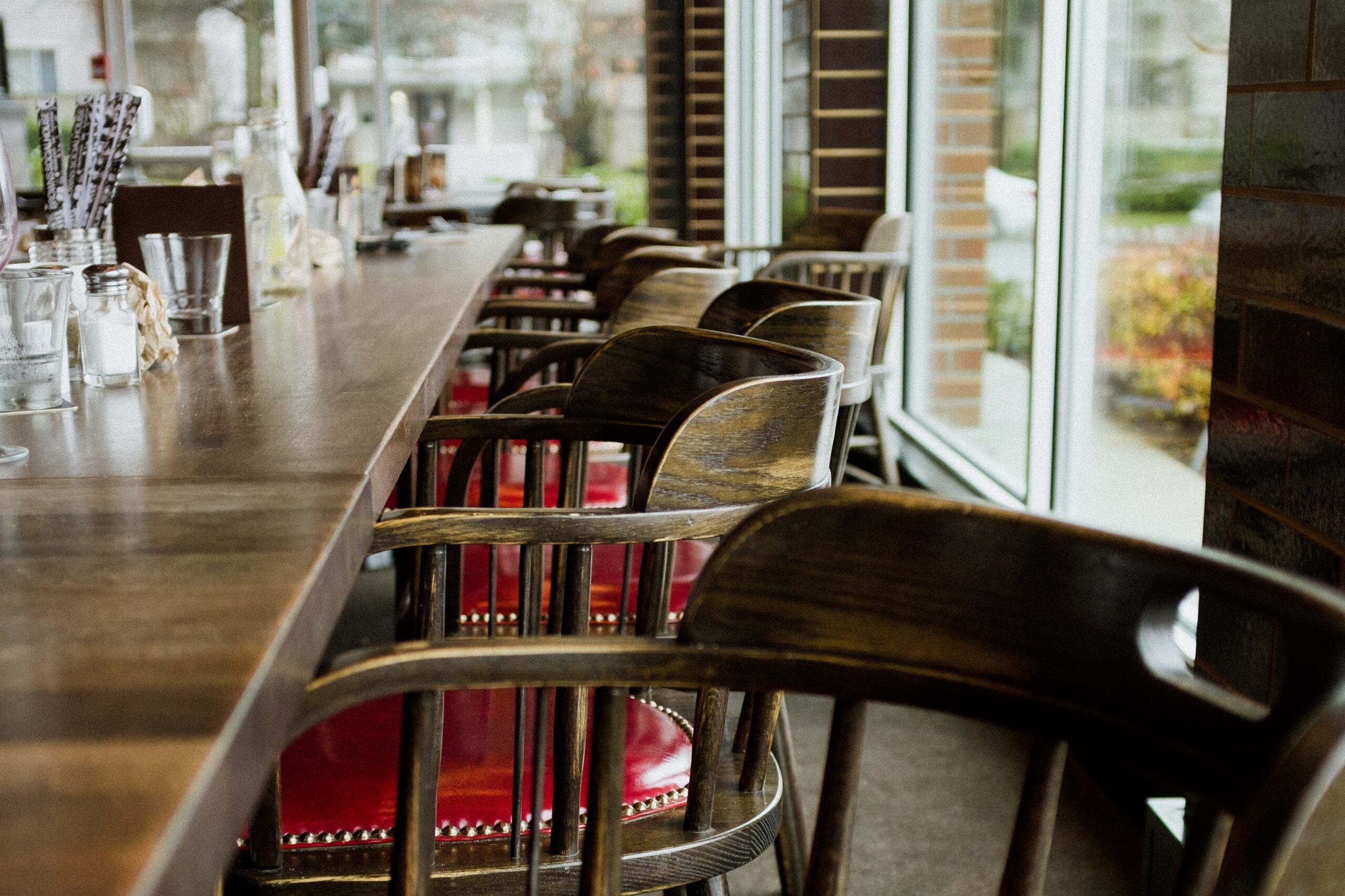 vacant red and gray chairs near long table
