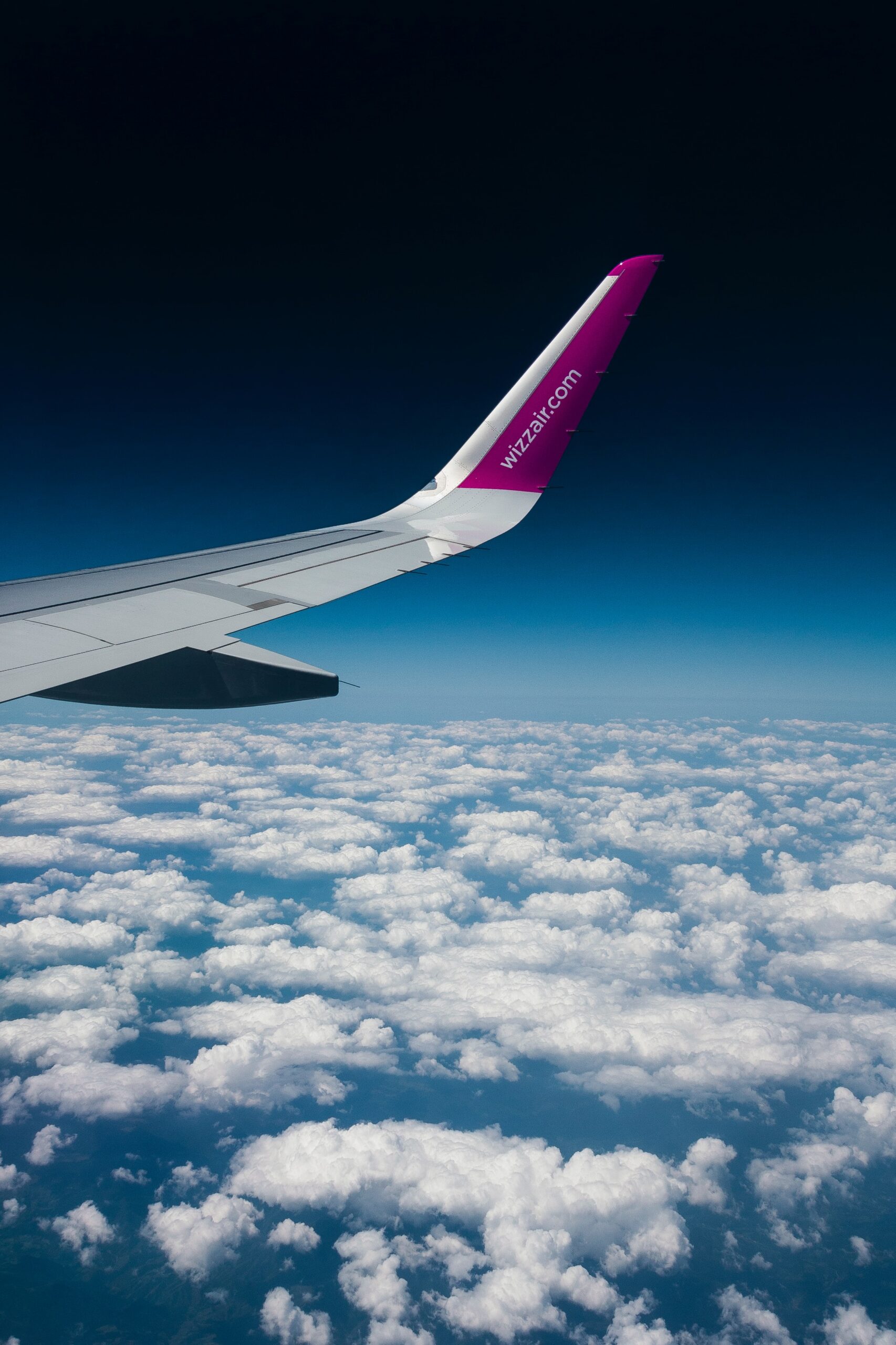 view of planes wings above clouds