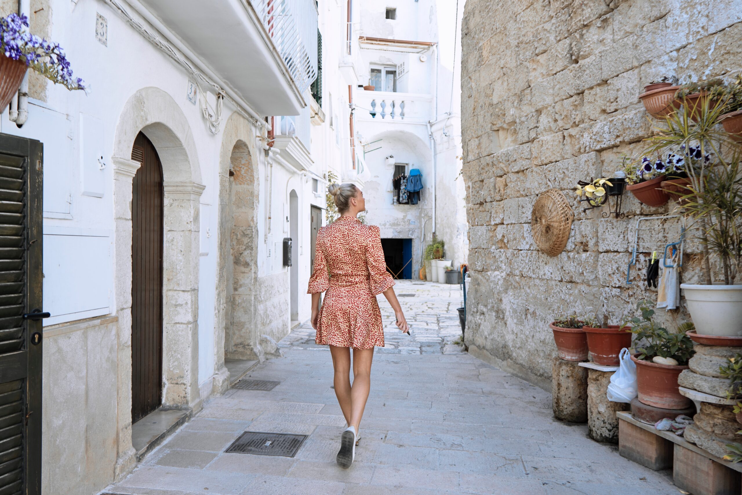 woman walking on hallway between walls