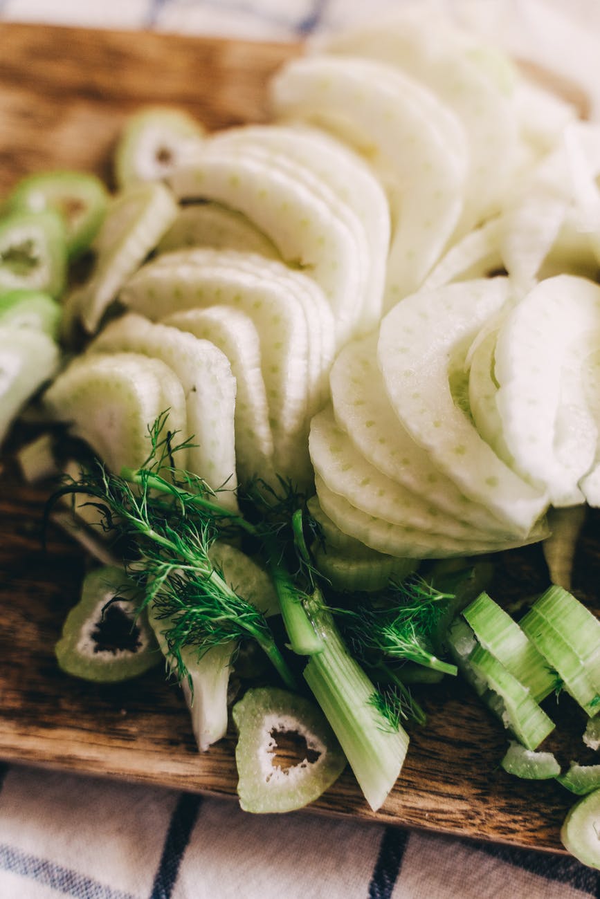 sliced white potatoes on brown wooden chopping board