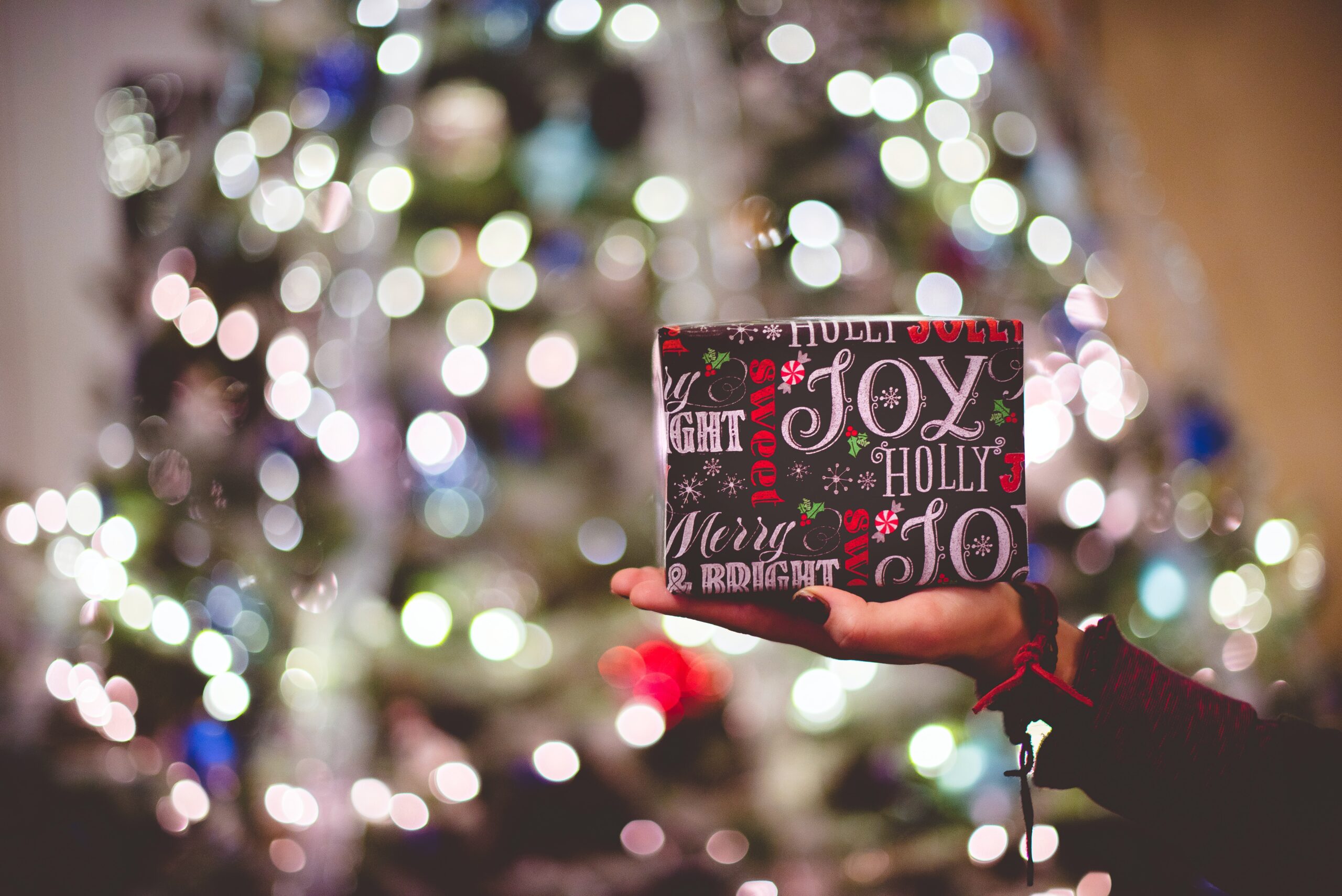 selective focus photography of gift box on person's palm