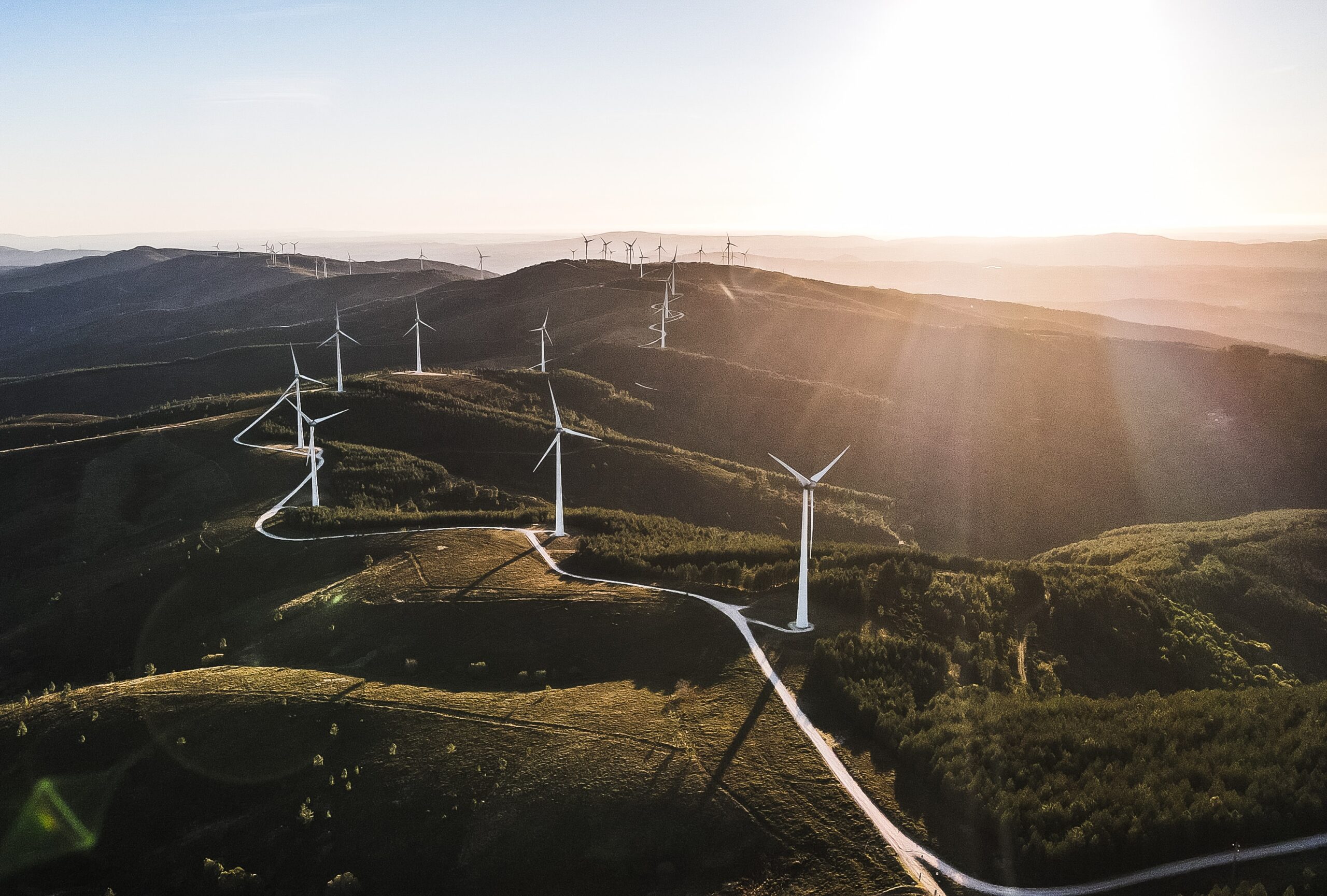 white wind turbines on green grass field during daytime