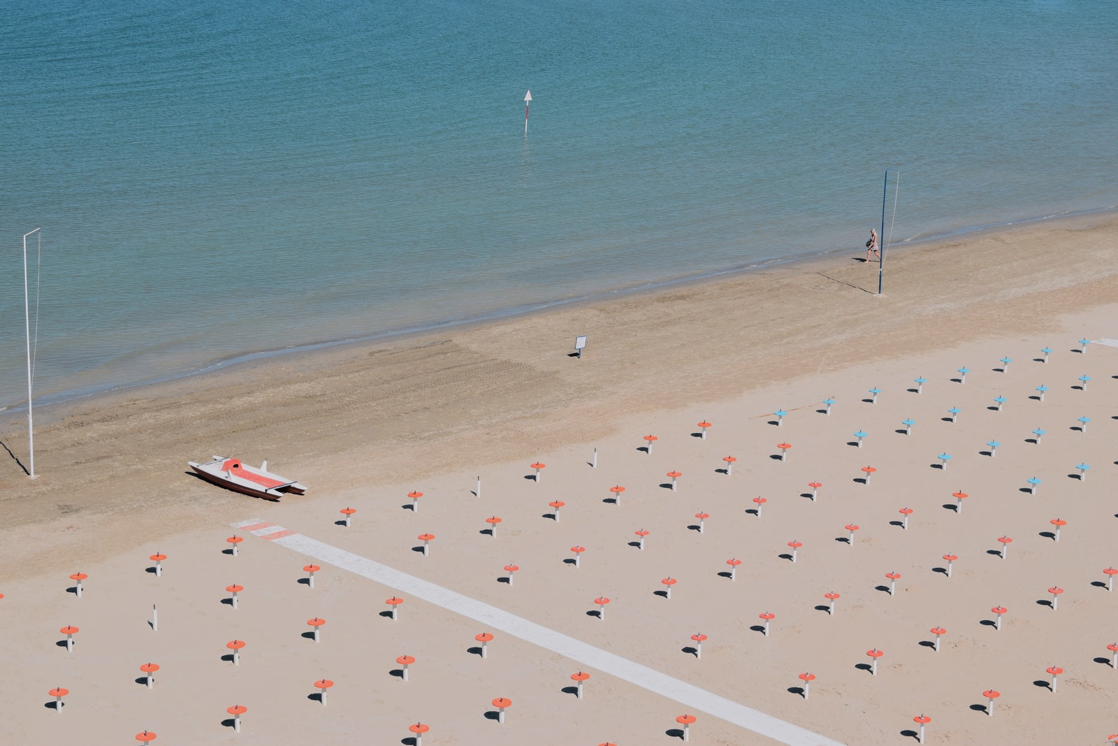 person and boat on shore during day