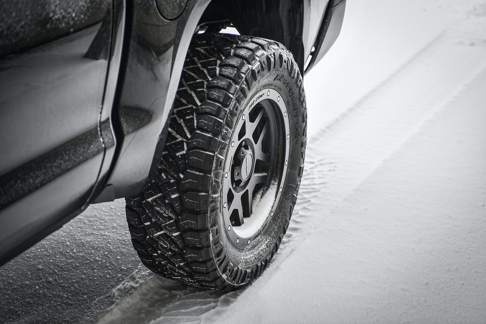 grayscale photo of car wheel