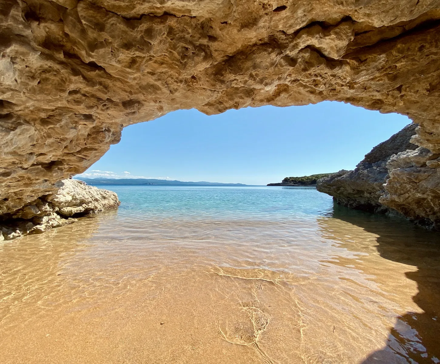 brown sand near body of water during daytime