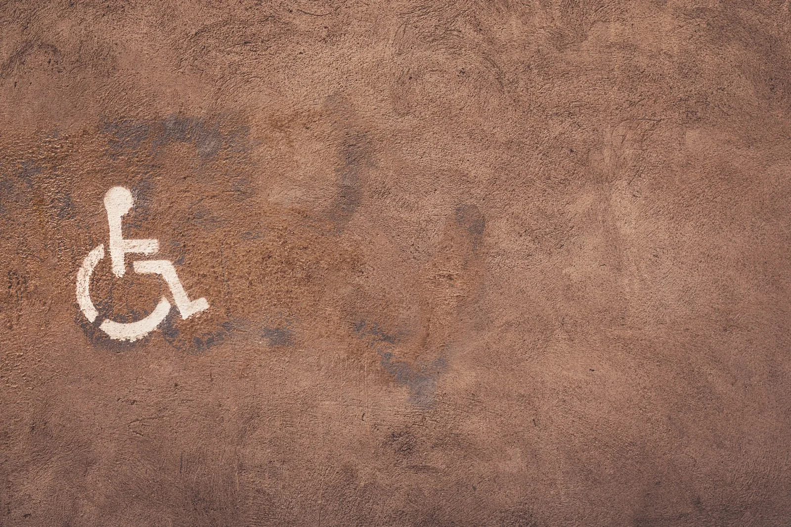 a handicap sign painted on the side of a wall