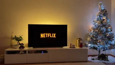a christmas tree in a living room next to a television