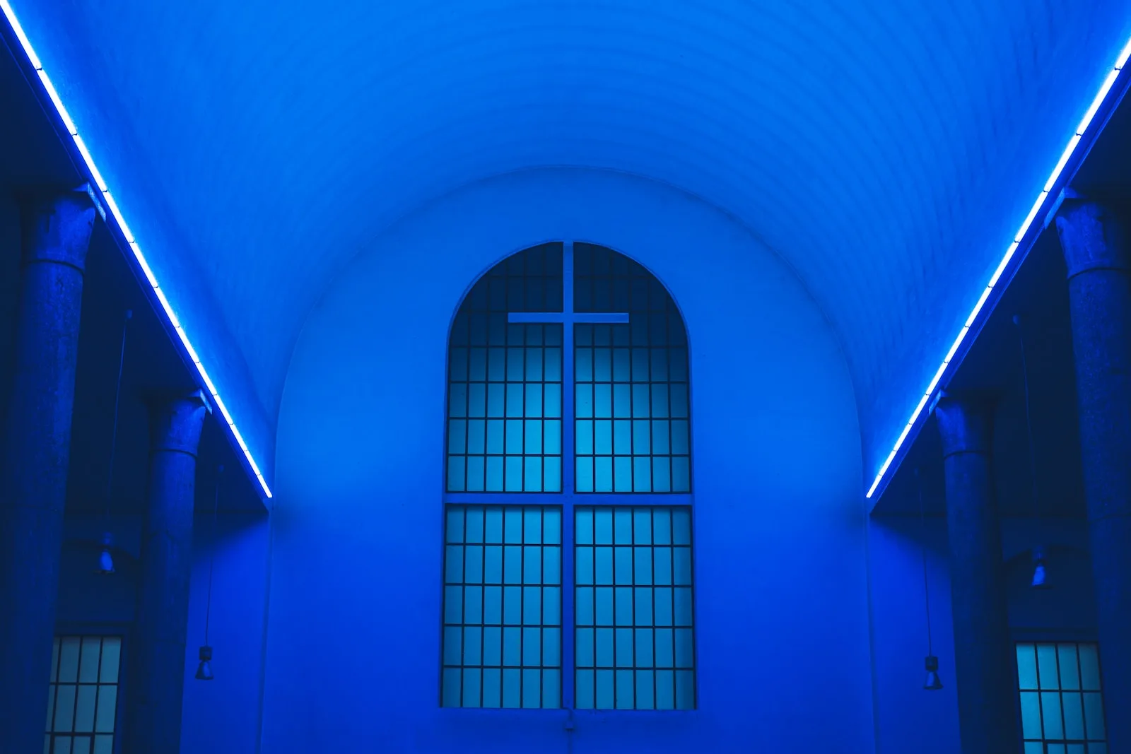blue lighted ceiling fronting the white cross