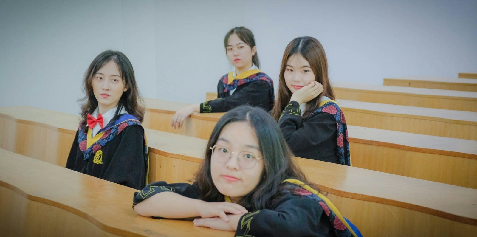 a group of girls sitting at a desk