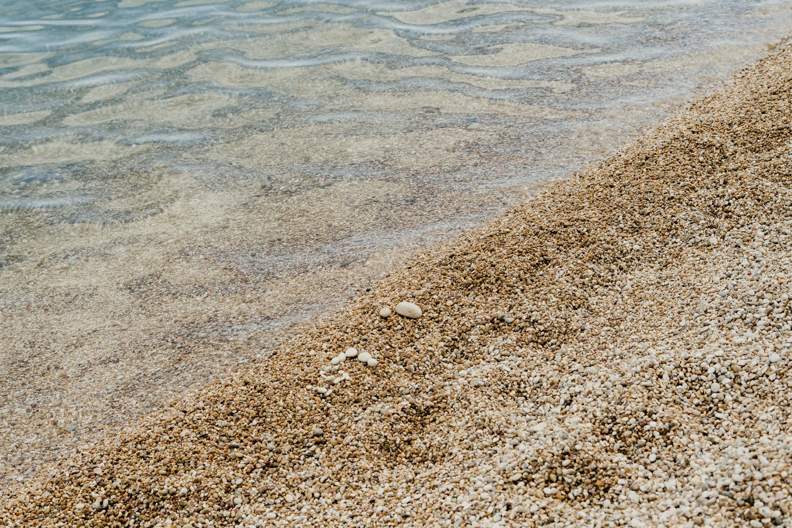white and brown stones on seashore during daytime
