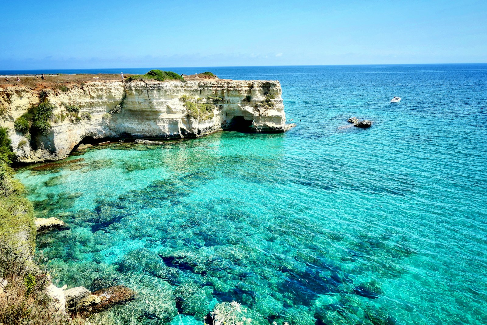 brown rock formation on blue sea during daytime