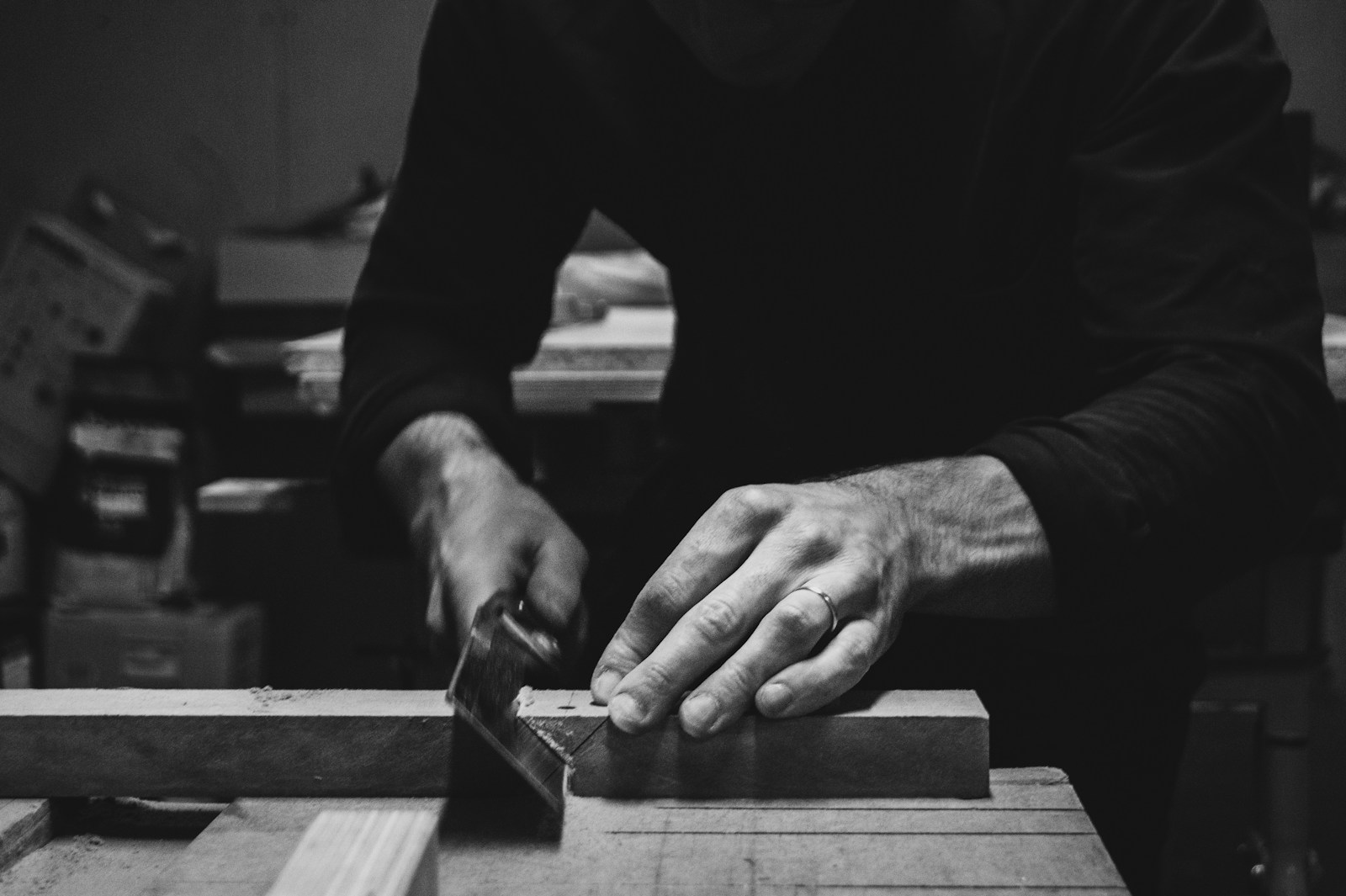 a man using a table saw to cut a piece of wood