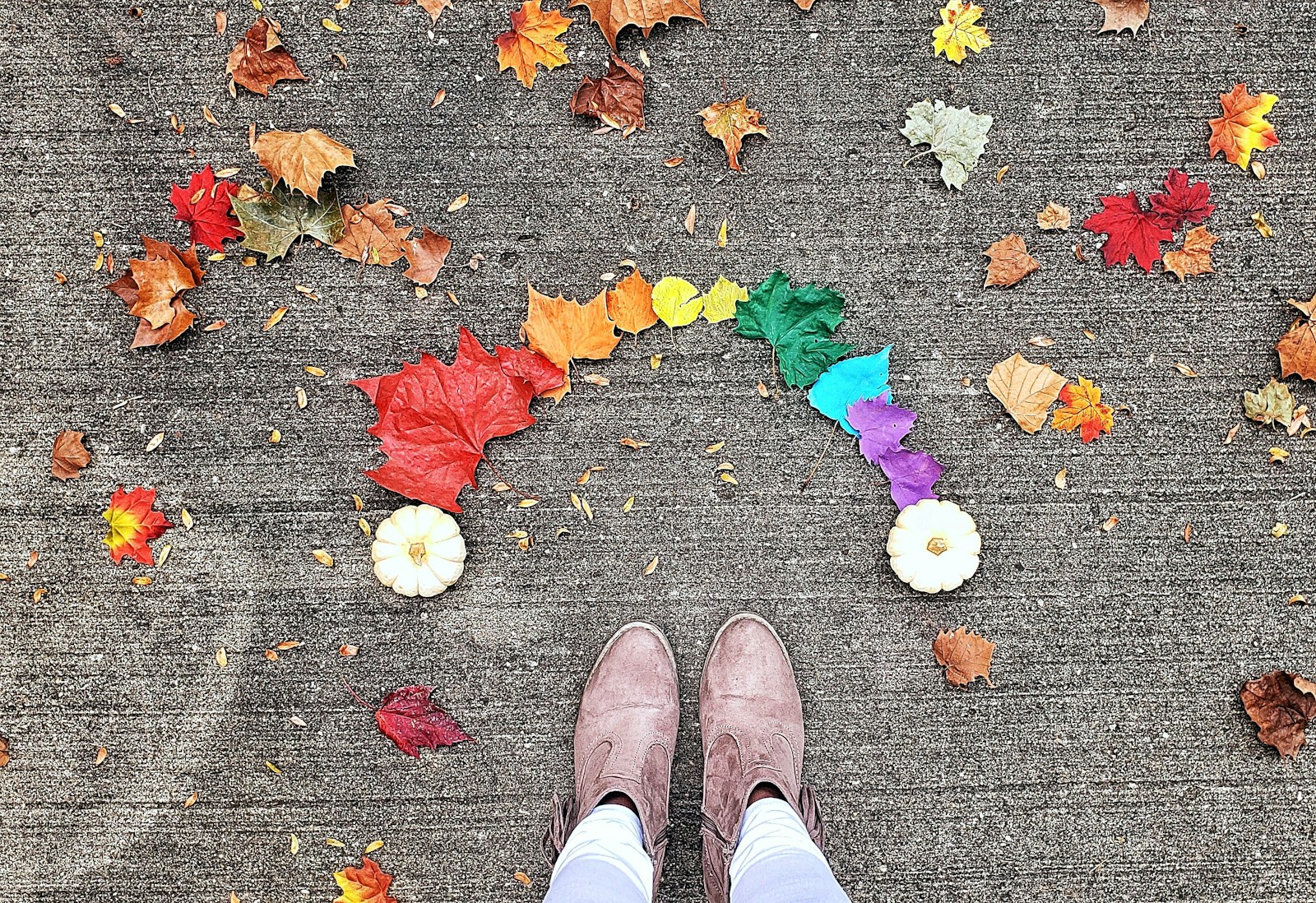 person wearing brown boots standing near leaves