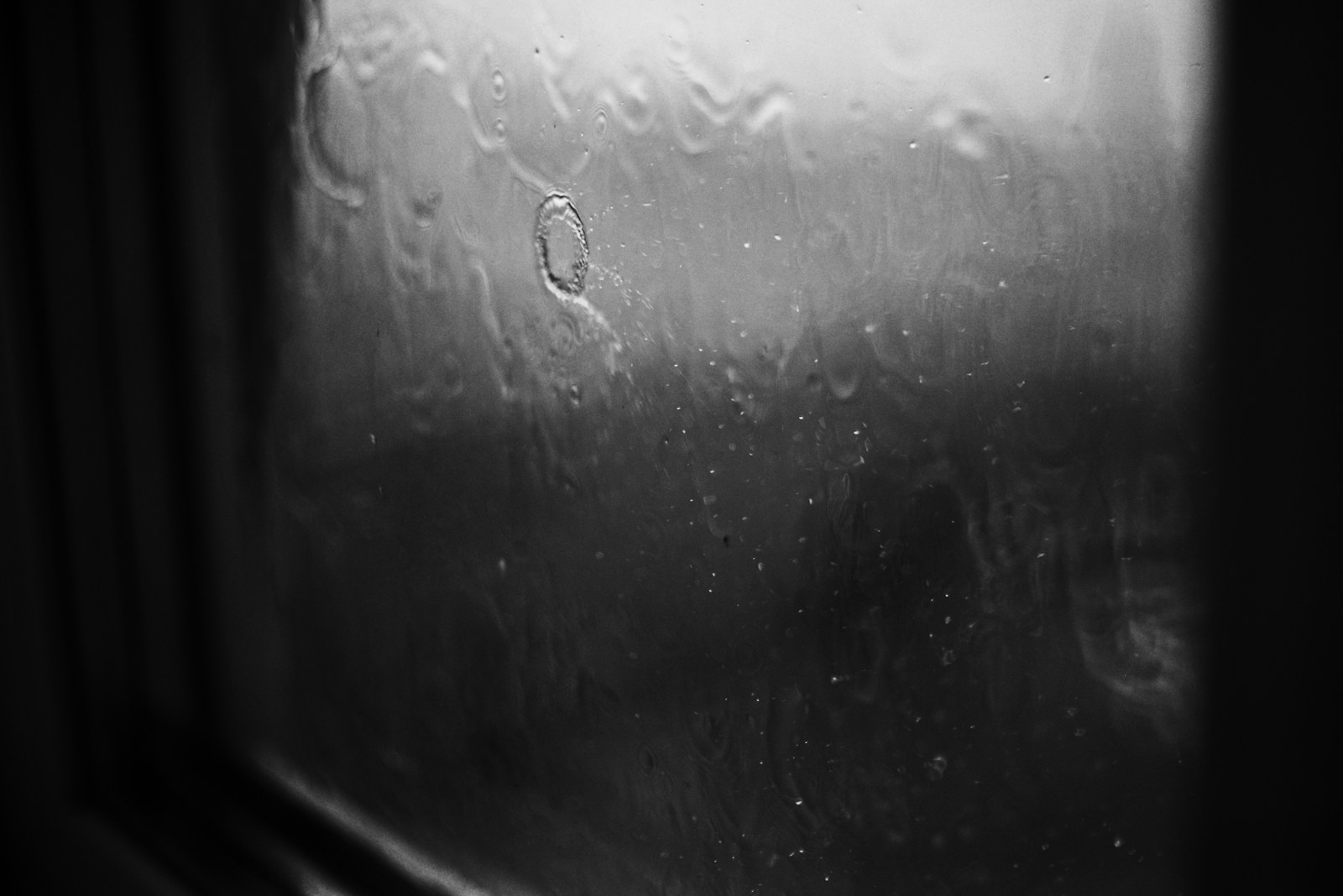 a close up of a window with rain drops on it