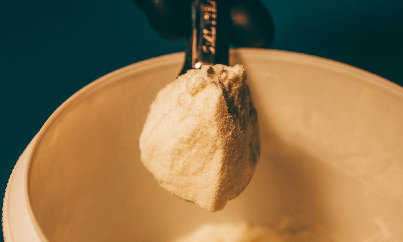 a person is holding a spoon with some food in it