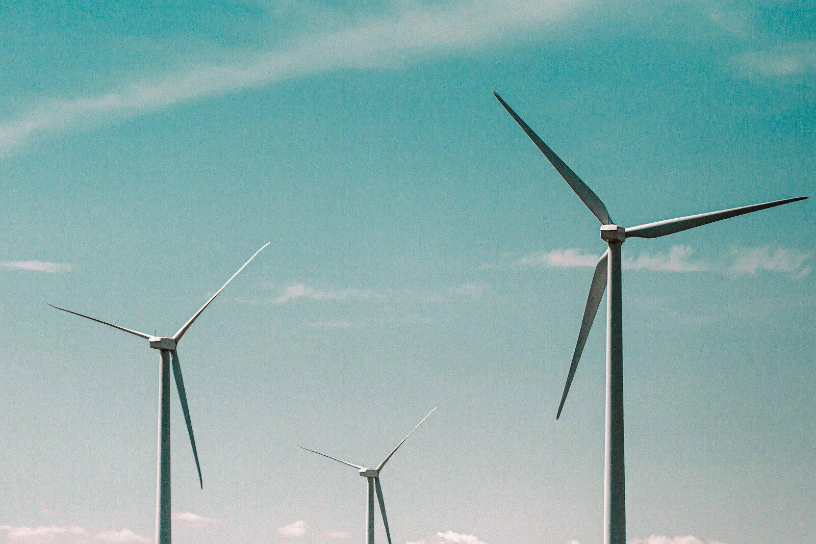 wind turbines under blue sky during daytime