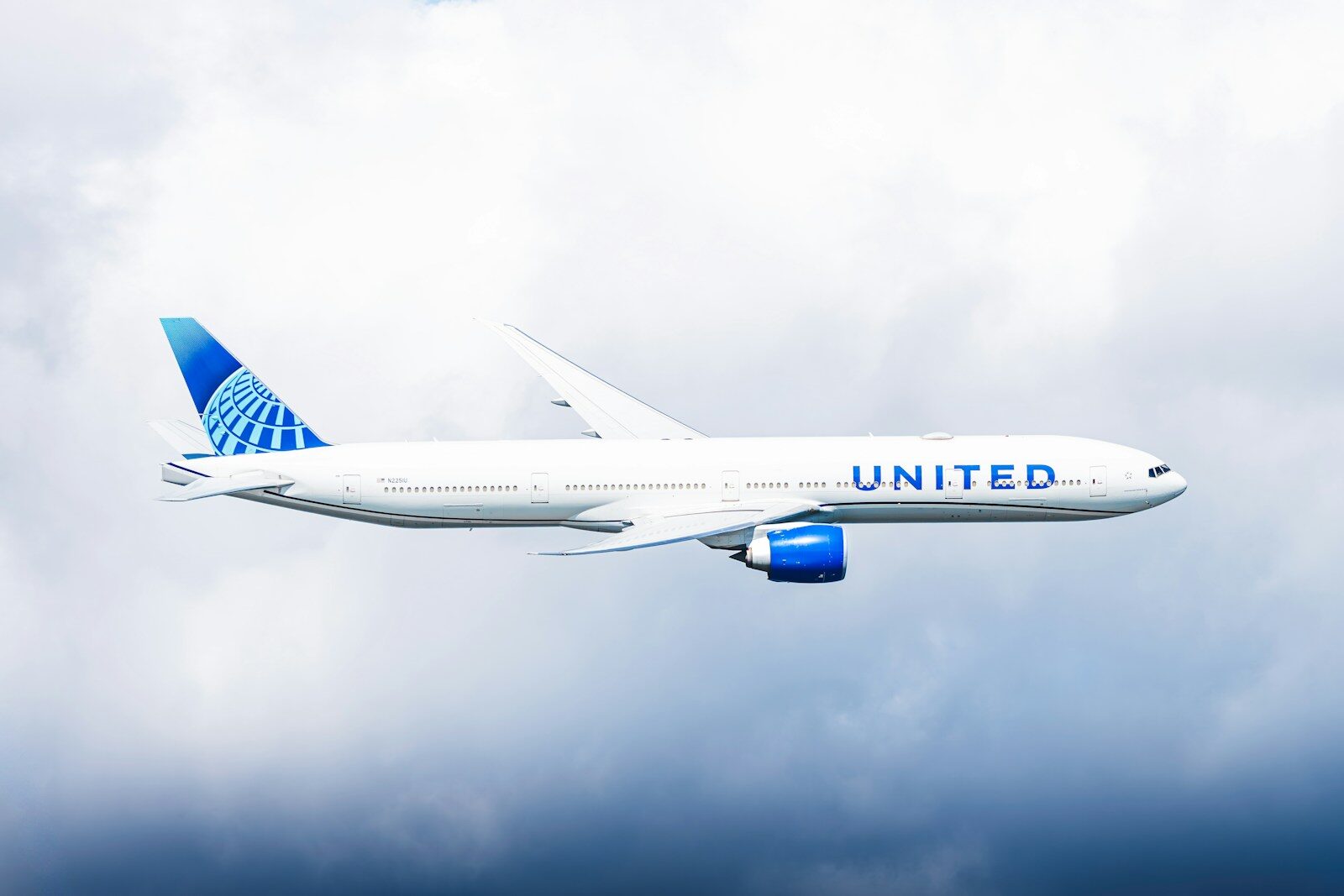 United airlines airplane flying through clouds